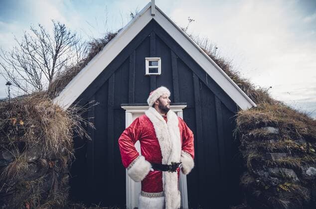 Iceland, Santa Claus standing in front of cabin looking at distance model released Symbolfoto  OCMF00179