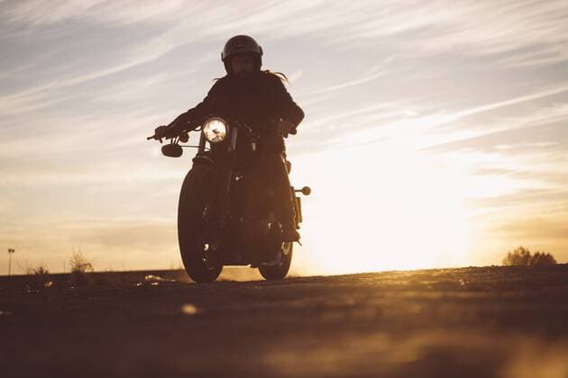 Silhouette of man riding custum motorcycle at sunset model released Symbolfoto  OCMF00226
