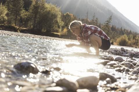 Austria, Alps, woman on a hiking trip having a break at a brook model released Symbolfoto  UUF16542
