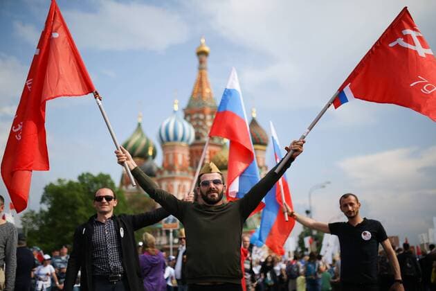 MOSCOW, RUSSIA - MAY 9, 2019: People carry portraits of their relatives who fought in World War II as they take part in the Immortal Regiment march in Red Square to mark the 74th anniversary of the Victory over Nazi Germany in the Great Patriotic War, the Eastern Front of World War II. Sergei Bobylev TASS  TS0AAEE6