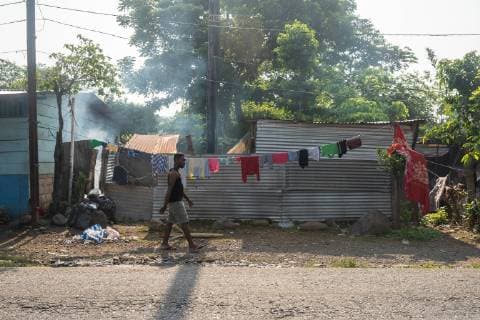 A man walks past a clothes line in Tapachula, Mexico on May 9, 2019. Migrants from Africa and Haiti have temporarily settled near the (INM) Instituto Nacional de Migracion Delegacion Federal en Chiapas building while hoping to apply for an exit visa so they can make their way to the US-Mexico border.  TP2019050901 ARIANAxDREHSLER