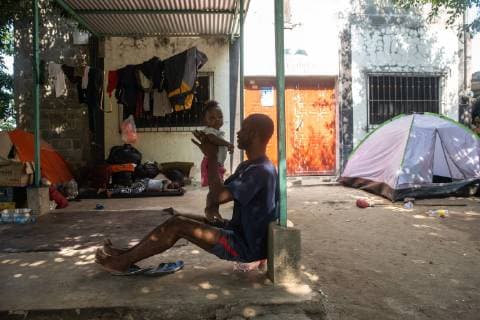 Cineac Kinchel from Haiti sits with his daughter Michele in Tapachula, Mexico on May 9, 2019. Kinchel s and his daughter have been staying where other migrants from Africa and Haiti have temporarily settled near the (INM) Instituto Nacional de Migracion Delegacion Federal en Chiapas building while hoping to apply for an exit visa so they can make their way to the US-Mexico border.  TP2019050904 ARIANAxDREHSLER