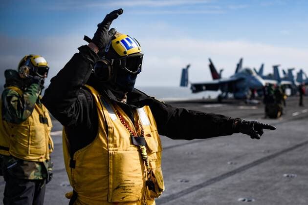 May 14, 2019 - Gulf of Alaska - Aviation Boatswain Mate 3rd Class Connor Akey, from Mobile, Ala., directs aircraft on the flight deck of the aircraft carrier USS Theodore Roosevelt (CVN 71) while participating in Exercise Northern Edge 2019. Northern Edge is one in a series of U.S. Indo-Pacific Command exercises in 2019 that prepares joint forces to respond to crisis in the Indo-Pacific region. Gulf of Alaska - ZUMAz03_ 20190514_sha_z03_831 Copyright: xU.S.xNavyx