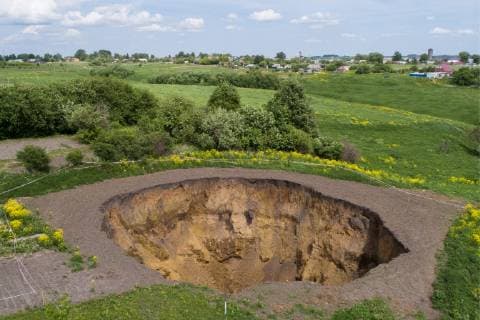TULA REGION, RUSSIA - MAY 22, 2019: An aerial view of a sinkhole about 30m in diameter and 15m in depth near the village of Dedilovo. Alexander Ryumin TASS  TS0AC398