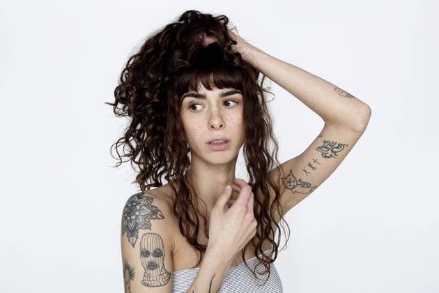 Portrait of tattooed young woman with hand in hair model released Symbolfoto  FLLF00124