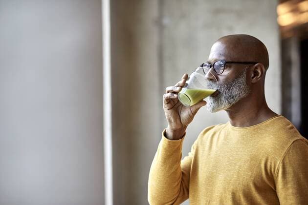 Mature businessman in office drinking a smoothie model released Symbolfoto property released  FMKF05501