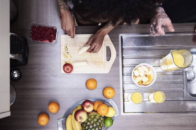 Top view of couple cutting fruit in kitchen model released Symbolfoto property released  IGGF01083