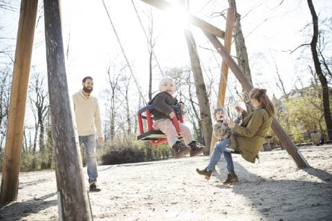Happy family on playground model released Symbolfoto  MAEF12839
