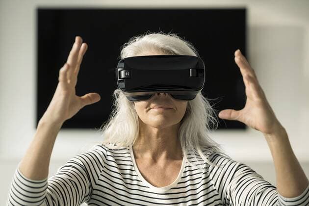 Portrait of mature woman using Virtual Reality Glasses at home model released Symbolfoto property released  SBOF01885