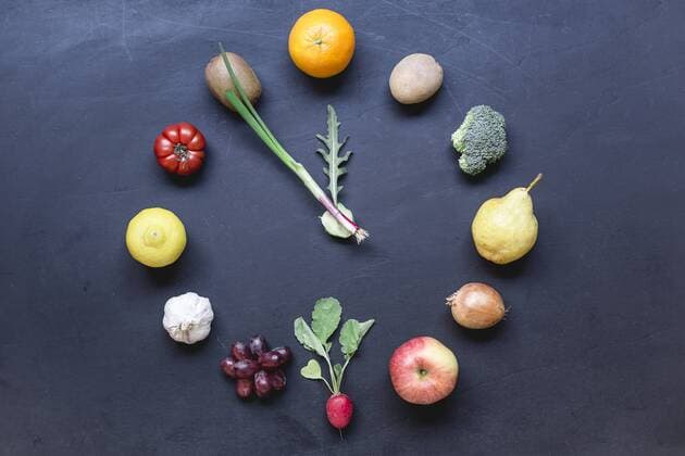 Fruits and vegetables buliding clock on dark ground  STBF00287
