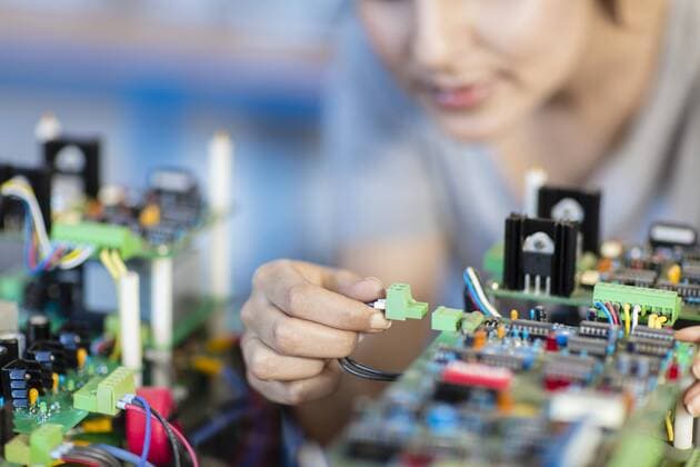 Detail of woman working on motherboard model released Symbolfoto property released  ZEF15282