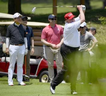 Trump in Japan U.S. President Donald Trump plays a shot as Japanese Prime Minister Shinzo Abe (L) looks on at Mobara Country Club in Chiba Prefecture, near Tokyo, on May 26, 2019. The two leaders played their fifth round of golf together since Trump took office in 2017. 