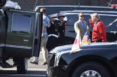 CORRECTED: Trump in Japan U.S. President Donald Trump (R) prepares to board a helicopter at Akasaka Press Center, a U.S. Army facility in Tokyo, on May 26, 2019. The helicopter was bound for the Mobara Country Club in Chiba Prefecture near Tokyo, where Trump was scheduled to play golf with Japanese Prime Minister Shinzo Abe later in the day -- their fifth round of golf together since the U.S. leader took office in 2017. 