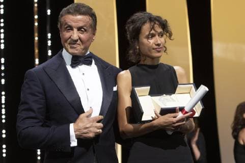 Mati Diop accepts the Grand Prize of the Festival for the movie Atlantique Atlantics) from US actor Sylvester Stallone at the award ceremony during the 72nd Cannes Film Festival at the Palais des Festivals on May 25, 2019 in Cannes, France