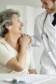Doctor consoling senior woman  Copyright: DinocoxGreco B89384637
