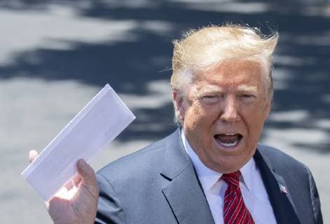 President Donald Trump holds up a letter that he says is the secret agreement with Mexico that put on hold the increase in tariffs, during an impromptu press conference on the South Lawn of the White House in Washington, DC on June 11, 2019. He then departed for Iowa.  WAS2019061103 PATxBENIC