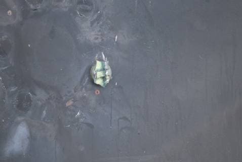 June 13, 2019 - Gilf of Oman - The aluminum and green composite material left behind following removal of an unexploded limpet mine used in an attack on the starboard side of motor vessel M T Kokuka Courageous, while operating in the Gulf of Oman, June 13, 2019. Gilf of Oman - ZUMAz03_ 20190613_sha_z03_290 Copyright: xDoDx
