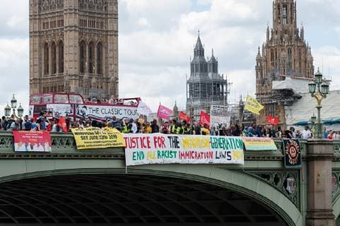 June 22, 2019 - London, Greater London, United Kingdom - A group of protesters mark the first official Windrush Day by dropping banners from Westminster Bridge with a message demanding justice for members of the Windrush Generation on 22 June, 2019 in London, England. The Windrush Day of Action, taking place simultaneously in seven cities across the UK, is part of an ongoing campaign against the impact of Government s hostile environment immigration policies and deportations from the UK to the Caribbean. Demonstrators call for a formal UN investigation into the Windrush scandal, an end to deportations and guarantee of full rights and compensations towards those affected by the scandal. London United Kingdom  - ZUMAn230 20190622_zaa_n230_357 Copyright: xWiktorxSzymanowiczx