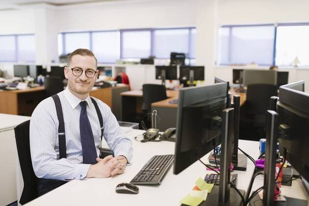 Portrait of confident businessman at desk in office model released Symbolfoto property released  AHSF00232