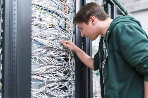 Teenager working with cables in server room model released Symbolfoto property released  DIGF06731