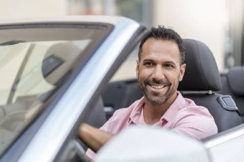 Portrait of smiling man driving convertible model released Symbolfoto  DIGF06985