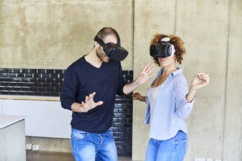Man and woman wearing VR glasses moving model released Symbolfoto property released  FMKF05623