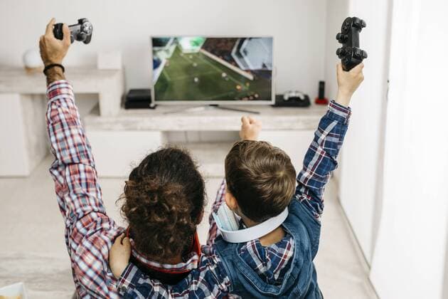 Father and son playing computer game at home model released Symbolfoto property released  JRFF02998