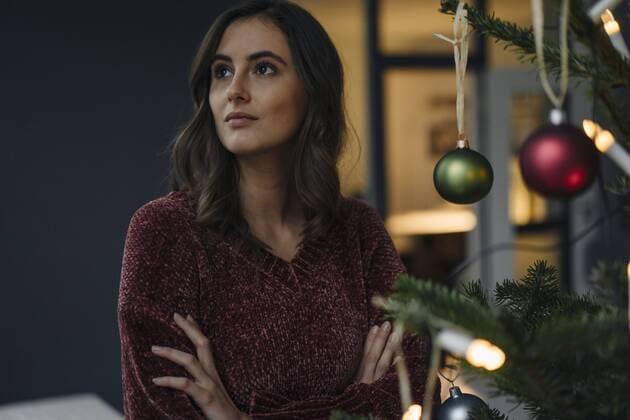 Young woman at decorated Christmas tree looking away model released Symbolfoto property released  KNSF05810