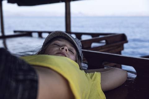 Indonesia, Komodo National Park, girl sleeping on a boat model released Symbolfoto  MCF00126