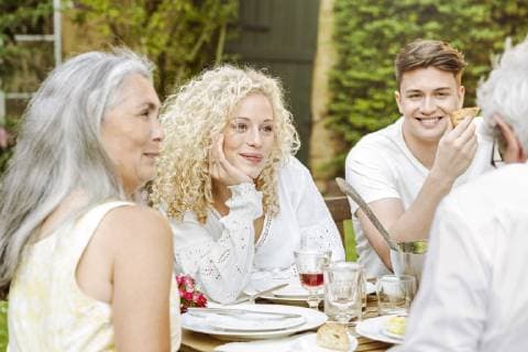 Happy family eating together in the garden model released Symbolfoto property released  PESF01642