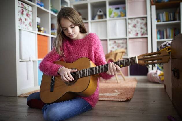 Girl exercising on her guitar model released Symbolfoto property released  RBF07022