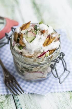 Glass of fried potato salad with cucumber, red radish, spring onions and mayonnaise yoghurt dressing  STBF00315