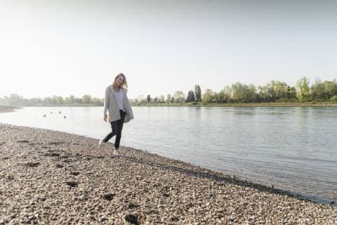Happy mature woman walking at the riverside model released Symbolfoto  UUF17572