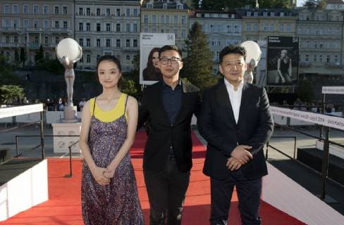 Actors Zhang Tongxi, left, and Wang Yanhui, right, and director Zhai Yixiang arrive to present Mosaic Portrait film at the 54th Karlovy Vary International Film Festival in Karlovy Vary, Czech Republic, on July 3, 2019. (CTKxPhoto KaterinaxSulova) CTKPhotoP201907031004701  suk3 k
