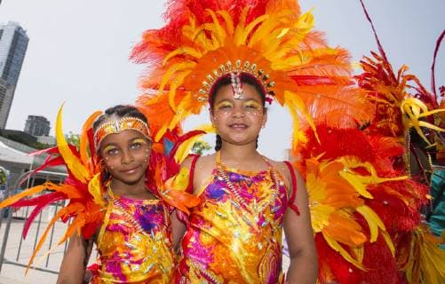 (190709) -- TORONTO, July 9, 2019 -- Dressed-up girls pose for photos during the official launch ceremony of the 2019 Toronto Caribbean Carnival in Toronto, Canada, July 9, 2019. The annual four-week cultural festival of Caribbean music, cuisine and revelry kicked off on Tuesday. King and Queen costume competition, Junior Carnival, Grand Parade and other events will be held during the festival. ) CANADA-TORONTO-CARIBBEAN CARNIVAL-LAUNCH CEREMONY ZouxZheng 