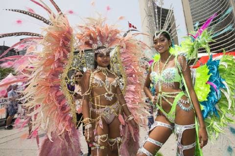 (190709) -- TORONTO, July 9, 2019 -- Dressed-up revelers pose for photos during the official launch ceremony of the 2019 Toronto Caribbean Carnival in Toronto, Canada, July 9, 2019. The annual four-week cultural festival of Caribbean music, cuisine and revelry kicked off on Tuesday. King and Queen costume competition, Junior Carnival, Grand Parade and other events will be held during the festival. ) CANADA-TORONTO-CARIBBEAN CARNIVAL-LAUNCH CEREMONY ZouxZheng 