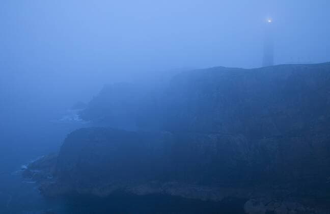 Lighthouse in mist at dusk, Butt of Lewis, Outer Hebrides, Scotland, UK, June 2009  1268486 WildxWondersxofxEuropexMunoz