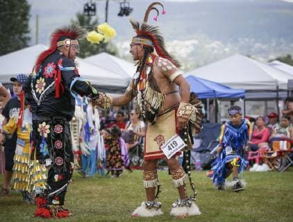 (190715) -- VANCOUVER, July 15, 2019 (Xinhua) -- People shake hands with each other during the 32nd annual Squamish Nation Youth Pow Wow at Capilano Reserve Park in west Vancouver, Canada, July 14, 2019. First Nations people from Canada and the U.S. took part in the 32nd annual Squamish Nation Youth Pow Wow in celebration of indigenous cultures. Pow Wow is an indigenous cultural activity in which people socialize together via different activities like dancing, singing, and honouring the traditions of their ancestors. (Xinhua Liang Sen) CANADA-VANCOUVER-SQUAMISH NATION YOUTH POW WOW 