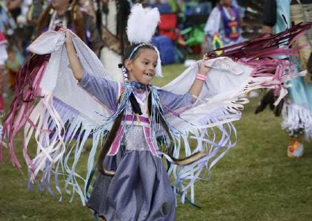(190715) -- VANCOUVER, July 15, 2019 (Xinhua) -- A girl performs during the 32nd annual Squamish Nation Youth Pow Wow at Capilano Reserve Park in west Vancouver, Canada, July 14, 2019. First Nations people from Canada and the U.S. took part in the 32nd annual Squamish Nation Youth Pow Wow in celebration of indigenous cultures. Pow Wow is an indigenous cultural activity in which people socialize together via different activities like dancing, singing, and honouring the traditions of their ancestors. (Xinhua Liang Sen) CANADA-VANCOUVER-SQUAMISH NATION YOUTH POW WOW 