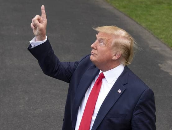 July 17, 2019 - Washington, District of Columbia, USA - United States President Donald J. Trump gestures towards the threatening skies as he answers questions as he prepares to depart the South Lawn of the White House in Washington, DC to deliver remarks at a Make America Great Again rally in Greenville, North Carolina on Wednesday, July 17, 2019. The President will return to the White House later this evening Washington USA - ZUMAs152 20190717_zaa_s152_069 Copyright: xRonxSachsx