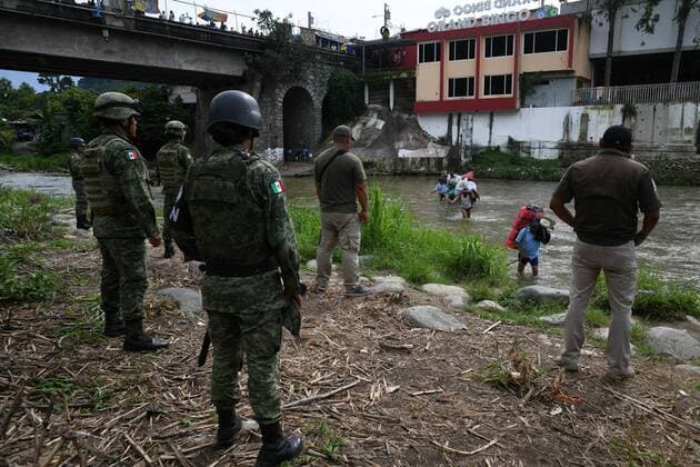July 24, 2019, Talisman, Chiapas, Mexico: Mexican marines and immigration officers check IDs of Guatemalan porters crossing goods illegally into Mexican territory on Wednesday. Hundreds of such crossings happen every day as the flow of migrants has moved to isolated spots along the Suchiate River, which marks the border between the two nations. Mexican President Lopez ObradorÃ¢â‚¬â ¢s administration claims to have reduced the flow of migrants looking to reach America, but much of the flow continues in remote border areas. Talisman Mexico - ZUMAl113 20190724_zap_l113_011 Copyright: xMiguelxJuarezxLugox