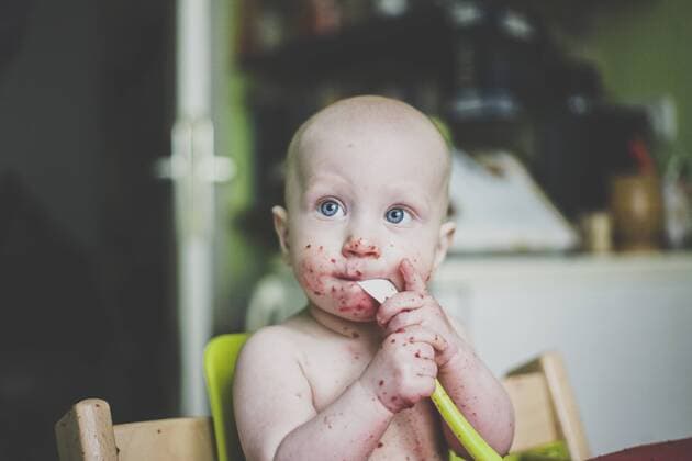 Baby boy making mess while eating model released Symbolfoto property released  IHF00154