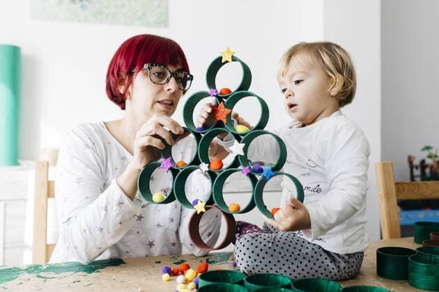 Mother and daughter doing crafts at home with accessories to make a Christmas tree model released Symbolfoto property released  JRFF03267