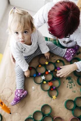 Top view of mother and daughter doing crafts at home with accessories to make a Christmas tree model released Symbolfoto property released  JRFF03272