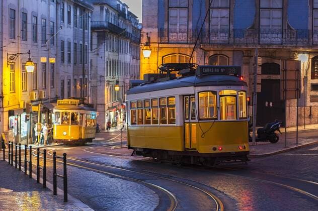  Trams crossing street at evening in Lisbon, Portugal  Copyright: xCAESARstockx Panthermedia19849271