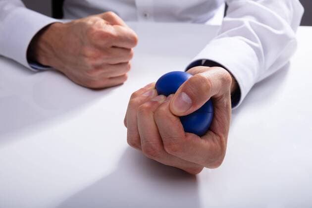  Businessman Pressing Stress Ball ,model released, Symbolfoto  Copyright: xAndreyPopovx Panthermedia25781822