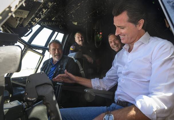 August 1, 2019, California, USA: California Gov. Gavin Newsom, right, and Former Gov. Arnold Schwarzenegger talk in a C-130 airplane cockpit with Cal Fire personnel at McClellan Air Force Base in Sacramento, Calif. Thursday, August 1, 2019. USA - ZUMAs76_ 20190801_zaf_s76_001 Copyright: xDanielxKimx