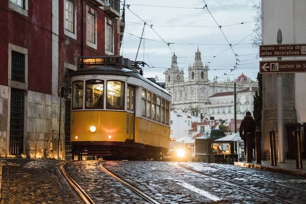 Romantic atmosphere in the old streets of Alfama with the castle in the background and tram number 28, Lisbon, Portugal, Europe Copyright: RobertoxMoiola 1179-1035