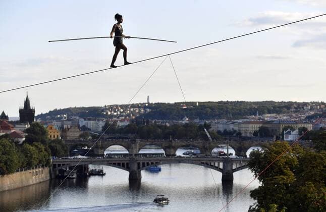 Entertainment Themen der Woche KW33 Entertainment Bilder des Tages French ropewalker Tatiana-Mosio Bongonga, from the Cie Basinga ensemble, crossed the Vltava River on a thin, 16-mm rope 35 metres above the water level in the centre in some 40 minutes at the opening of the Summer Letna international festival of new circus and theatre in Prague, Czech Republic, August 14, 2019. Thousands of people were watching and applauding her performance from the embankment, the Cech Bridge and the Letna park. Bongonga, 35, who has been waLking on the rope since the age of eight, crossed the Vltava (Moldau) River without any visible support, using a four-metre-long balance pole, weighing 12 kilos. (CTKxPhoto VitxSimanek) CTKPhotoP201908140796201  _VIS3928