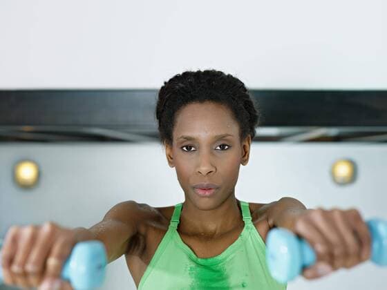  young african american woman in green sportswear doing weight lifting in fitness club. Horizontal shape, front view, copy space,model released, Symbolfoto  Copyright: xdiego.cervox Panthermedia04208213